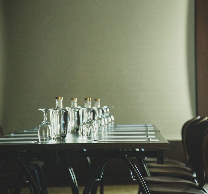 Elegant meeting table setup in Blue Restaurant, Vintage Hotel for professional gatherings.