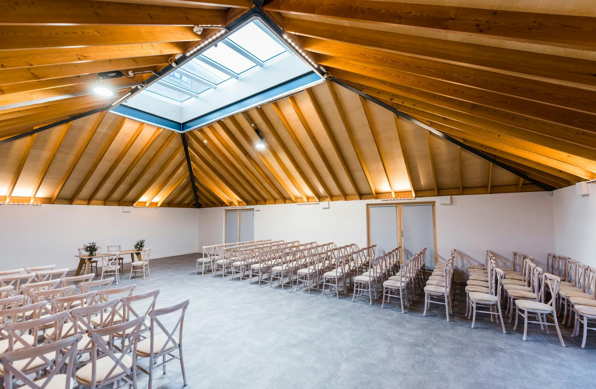 Sky Room at The Glass House: modern rustic event space with high wooden ceiling, ideal for ceremonies.