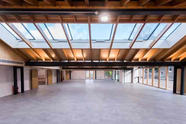 Spacious event venue with high ceilings and natural light for conferences and gatherings.