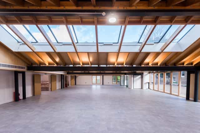 Spacious event venue with high ceilings and natural light for conferences and gatherings.