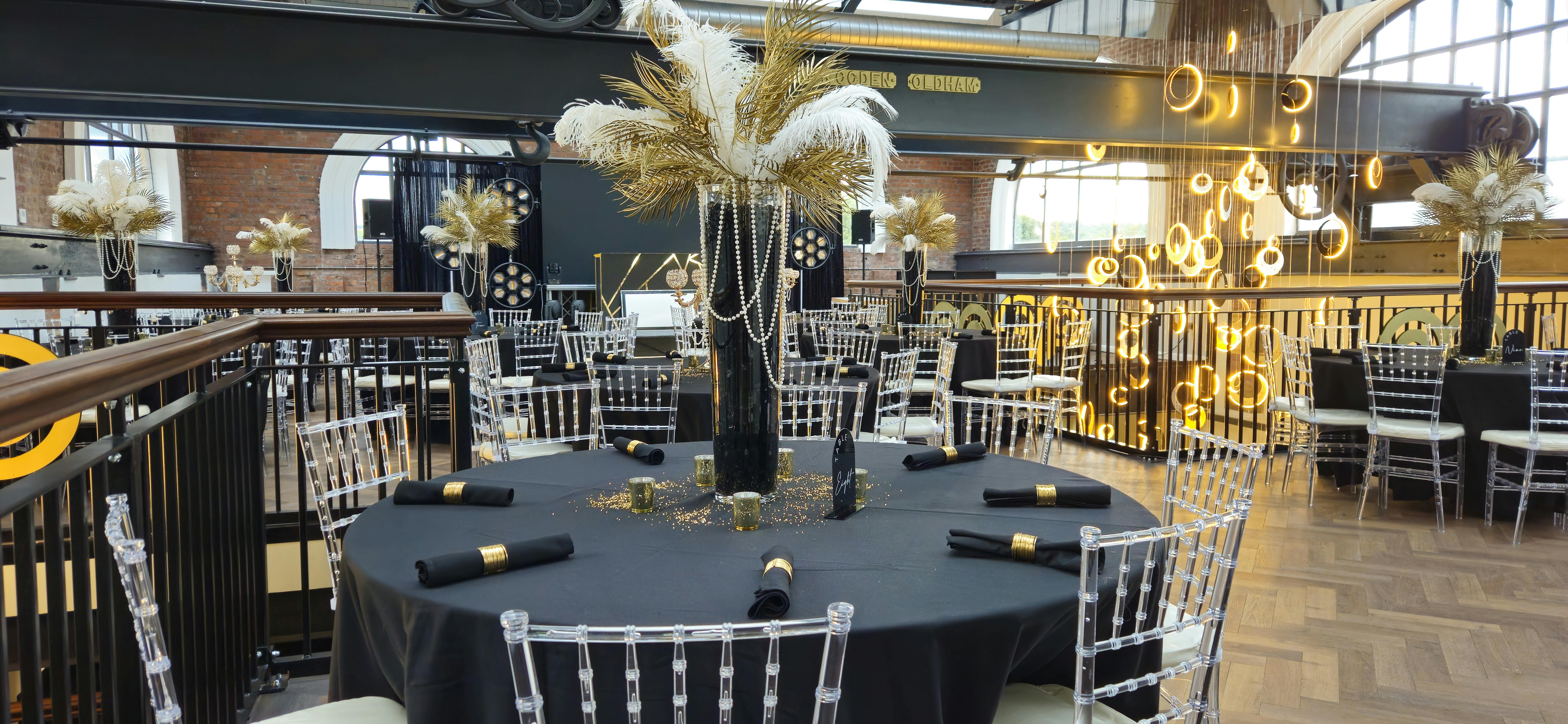 Elegant event space at Heritage 1907, featuring black tables and luxurious decor.