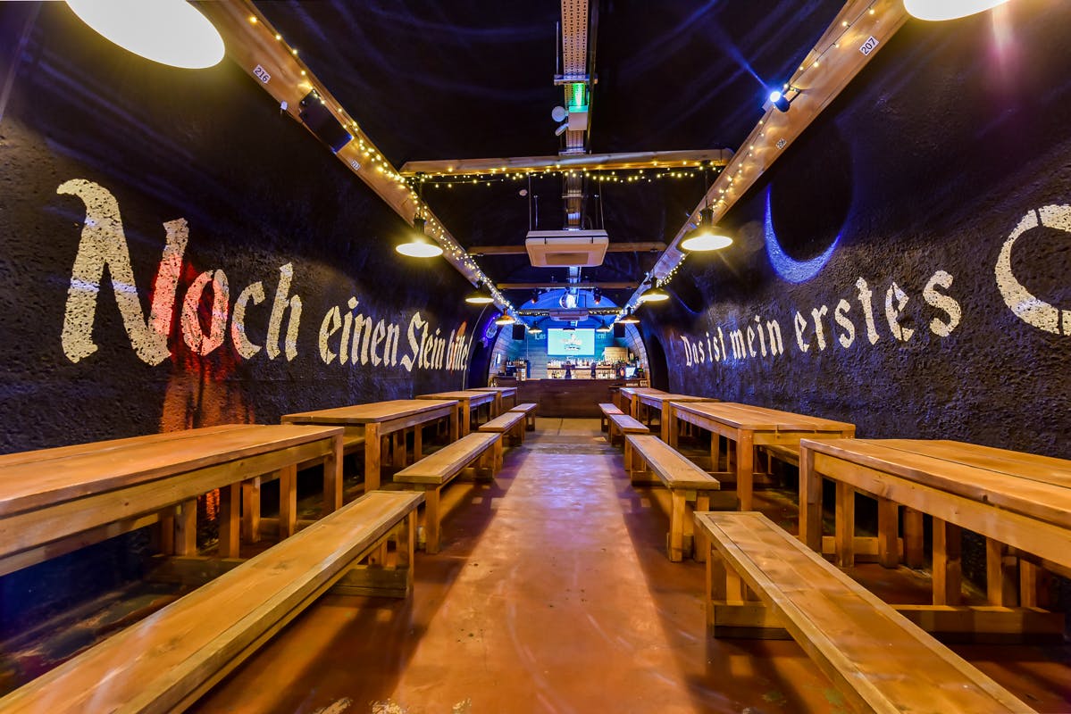 Bermondsey Bierkeller: rustic event space with wooden benches for gatherings and presentations.