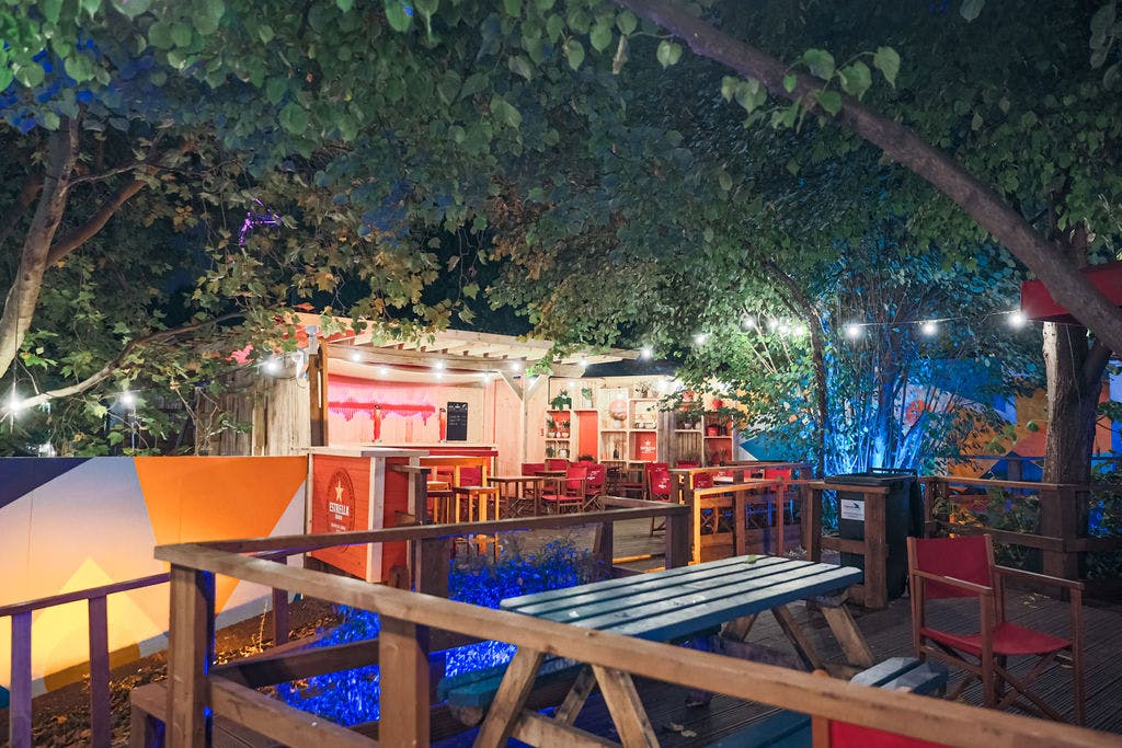 Vibrant outdoor event space with lush greenery for casual gatherings and networking.