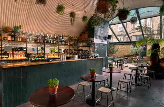 Industrial-chic venue with vaulted ceiling for corporate evening receptions and networking mixers.