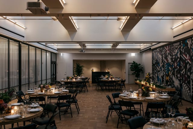 Elegant event space at The Emily Hotel with round tables, perfect for corporate gatherings.
