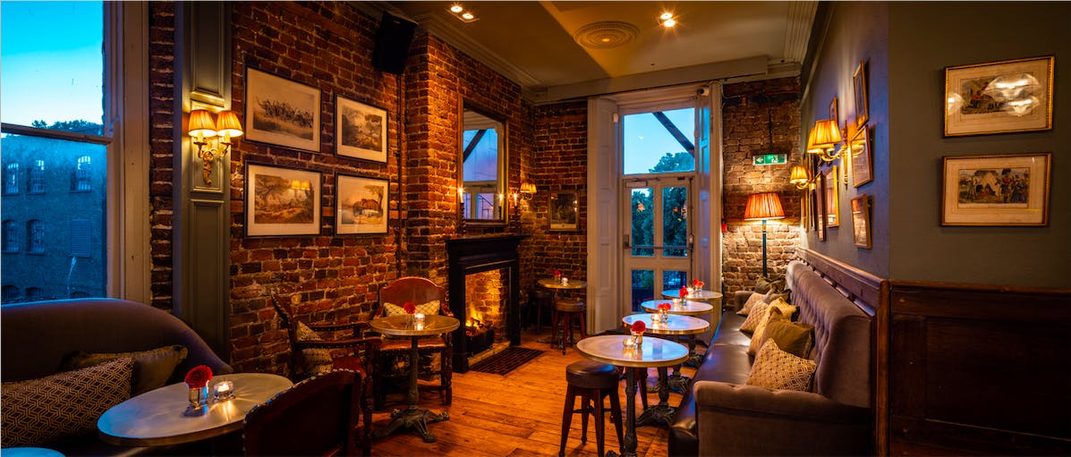 Cozy Cocktail Lounge with rustic brick walls, perfect for intimate gatherings and networking events.