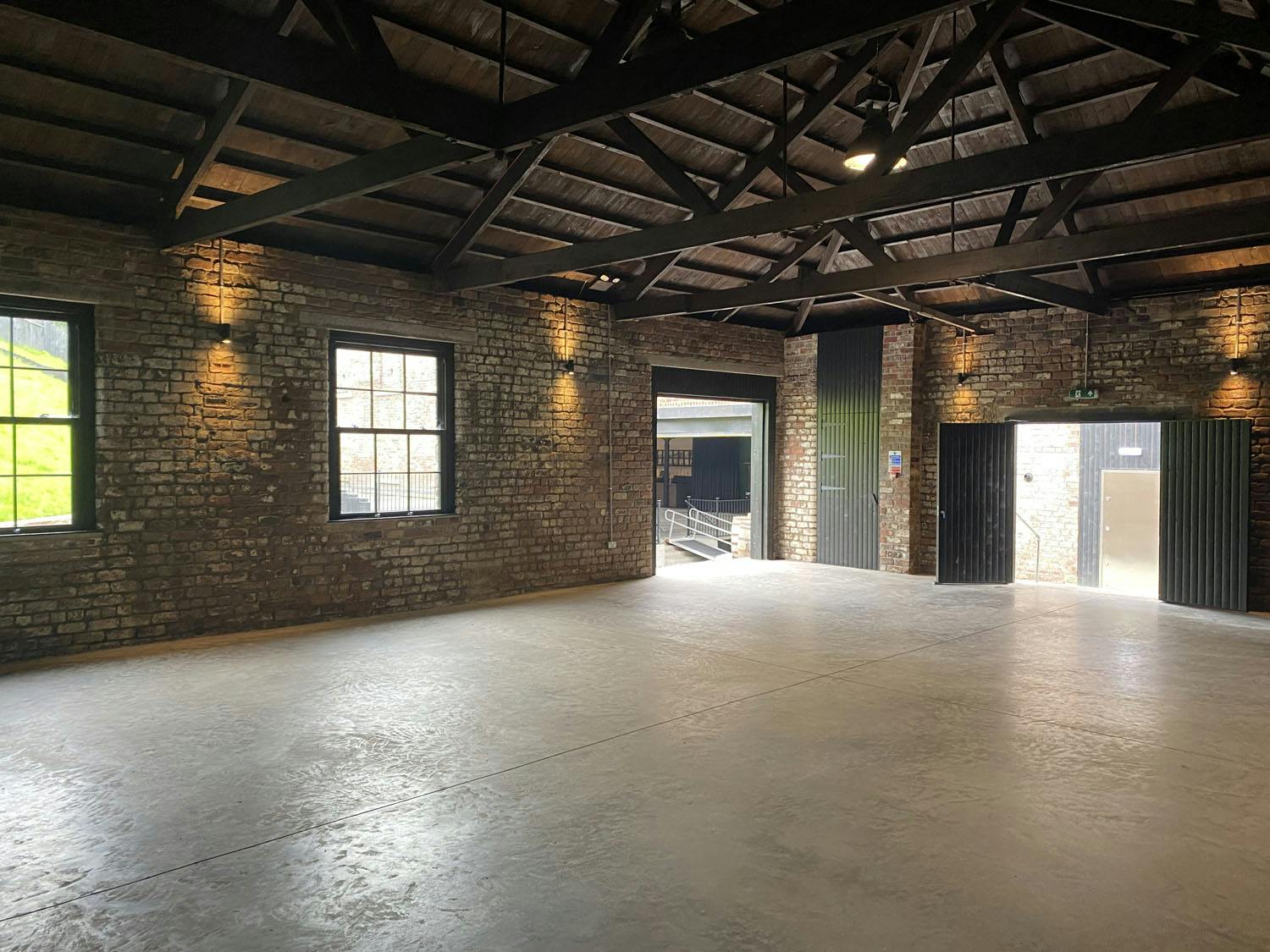 Versatile event space with exposed brick walls, ideal for workshops and receptions.