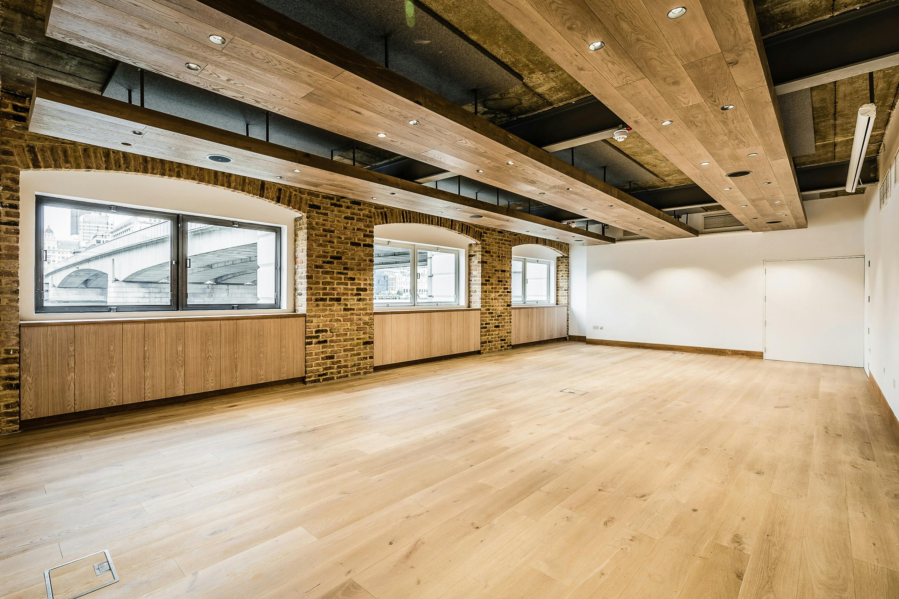 The Bridge Room at Glaziers Hall: modern event space with large windows for natural light.