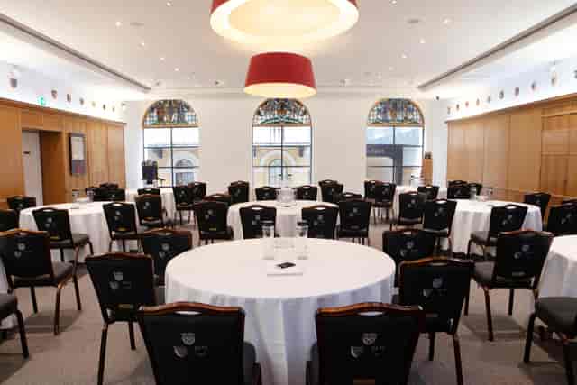 Elegant meeting room with round tables, ideal for networking events at Glaziers Hall.
