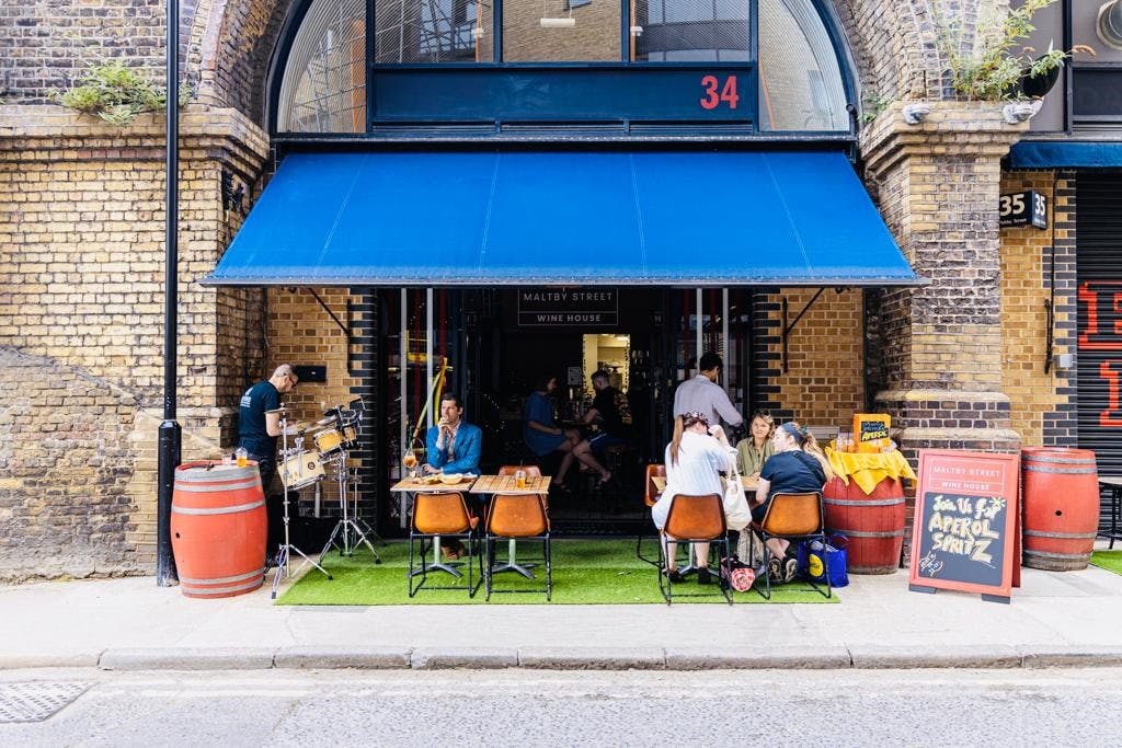 Vibrant outdoor café at Maltby Street Wine House, perfect for casual networking events.