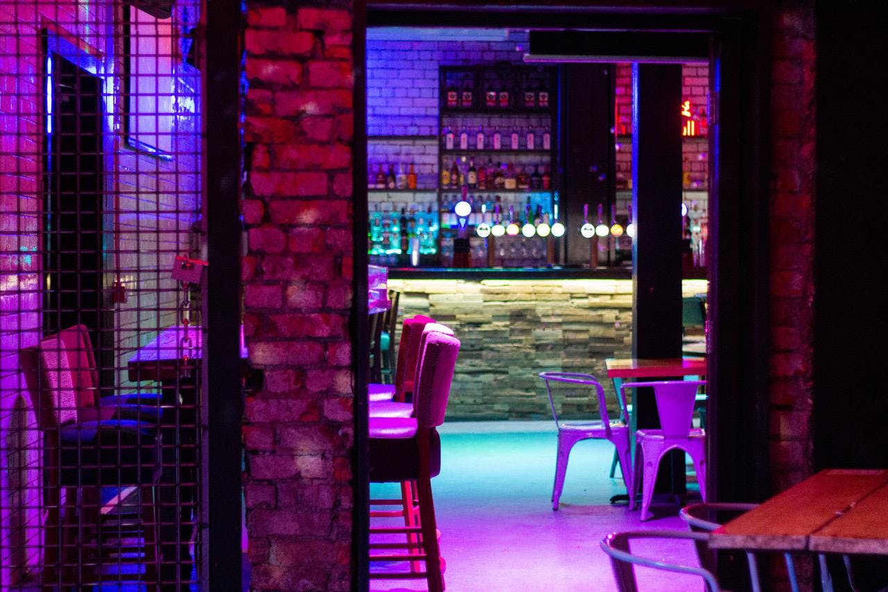 Vibrant bar venue with colorful lighting for events and gatherings at The Lost Weekend.