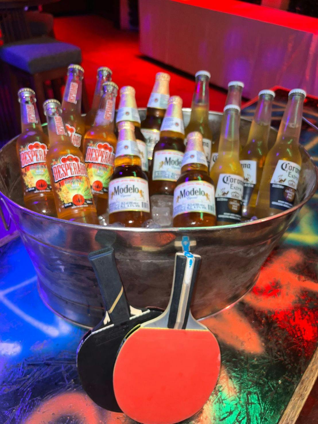 Stylish ice bucket with beers at The Lost Weekend, perfect for networking events.