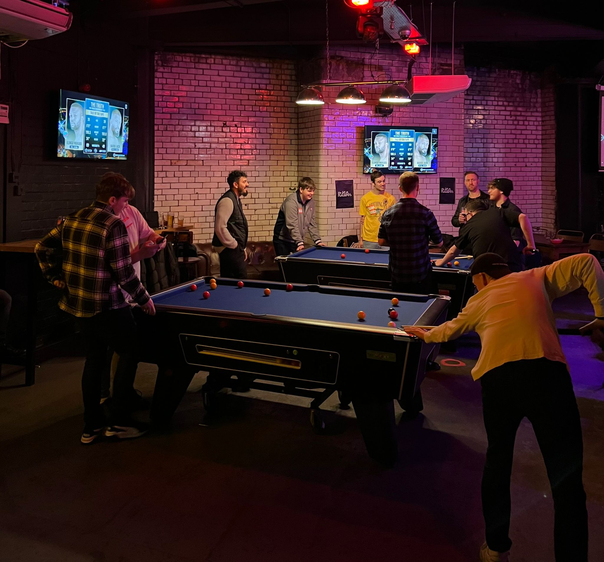 Vibrant social event space with pool tables for networking and team-building activities. - Banner