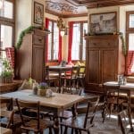 Cozy Augustiner Room with warm wood tones, ideal for intimate meetings and events.