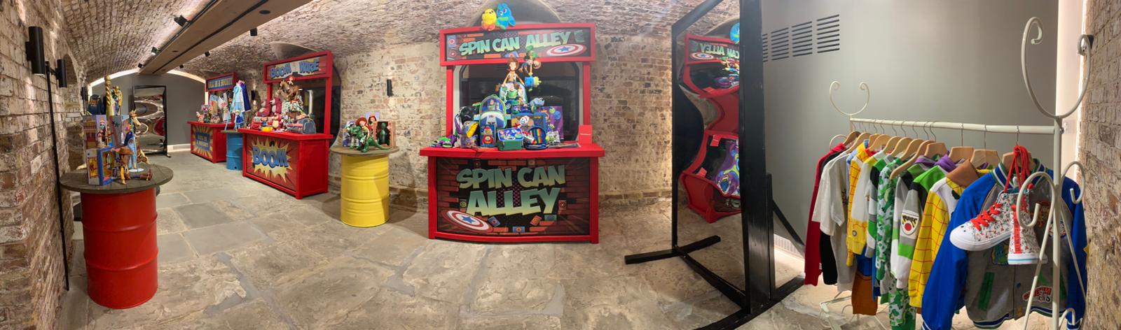 London Bridge Arches event space with colorful "Spin Can Alley" game booth for networking. - Banner