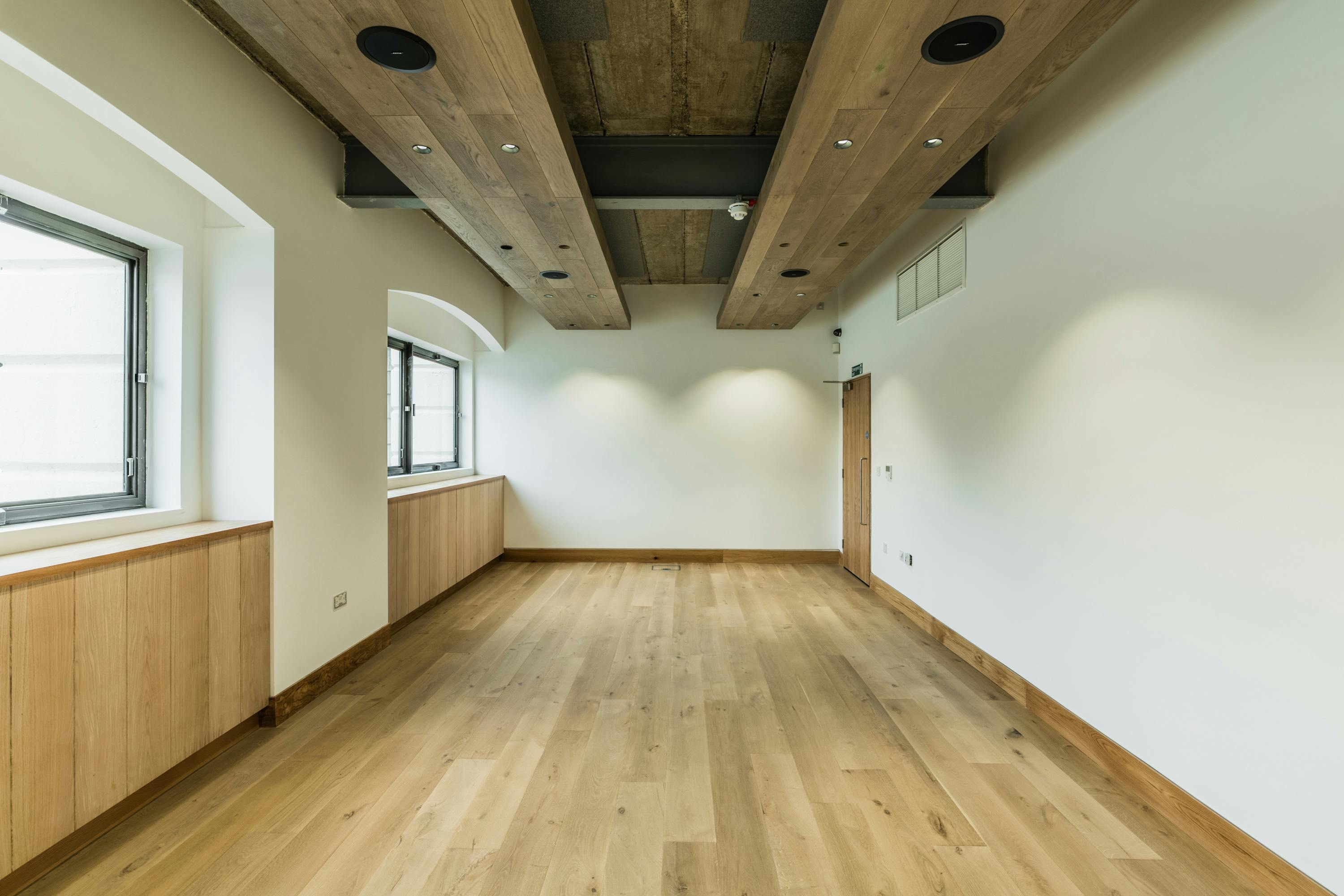 Thames Room at Glaziers Hall: modern event space with warm wood accents for meetings.