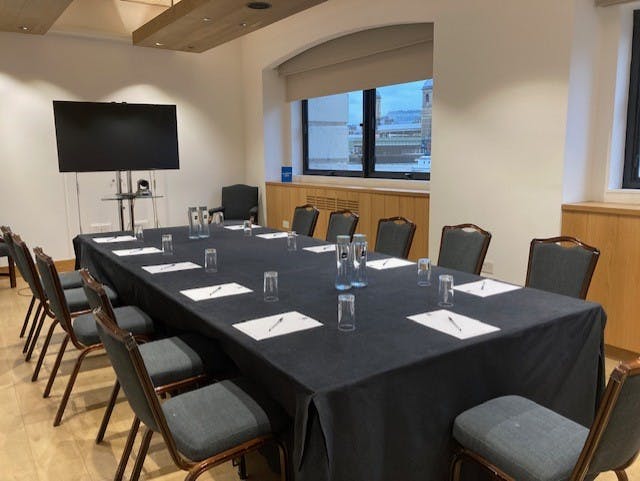 Thames Room at Glaziers Hall, set for professional meetings with natural light.