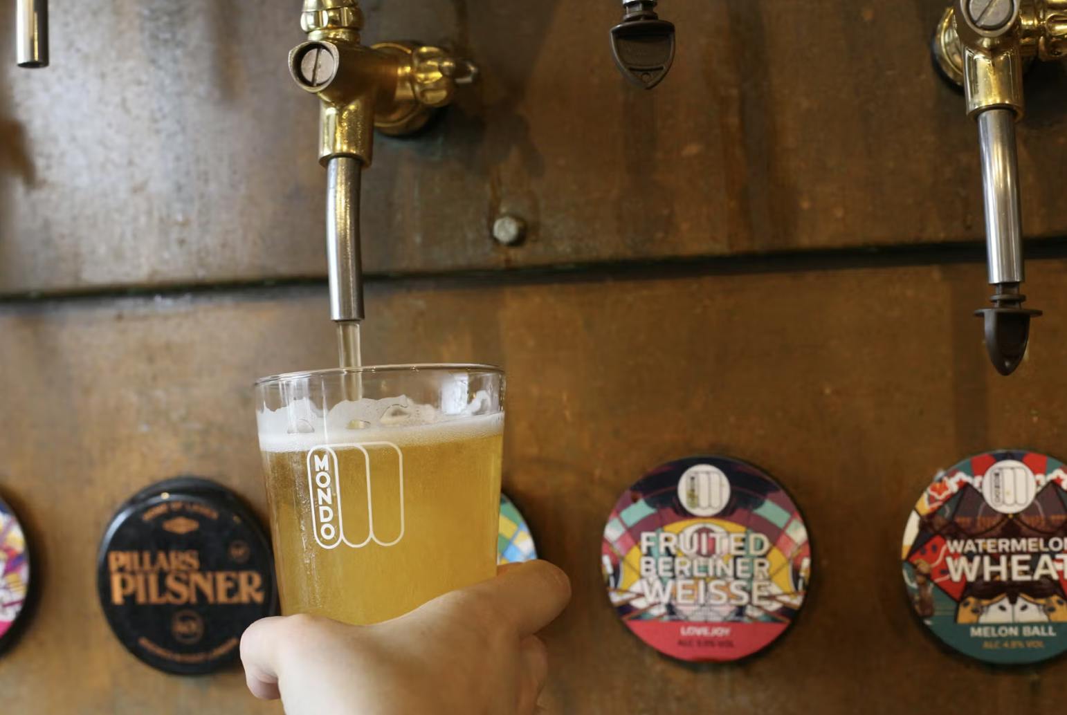Vibrant bar at Mondo Brewing, perfect for networking events with craft beers on tap.