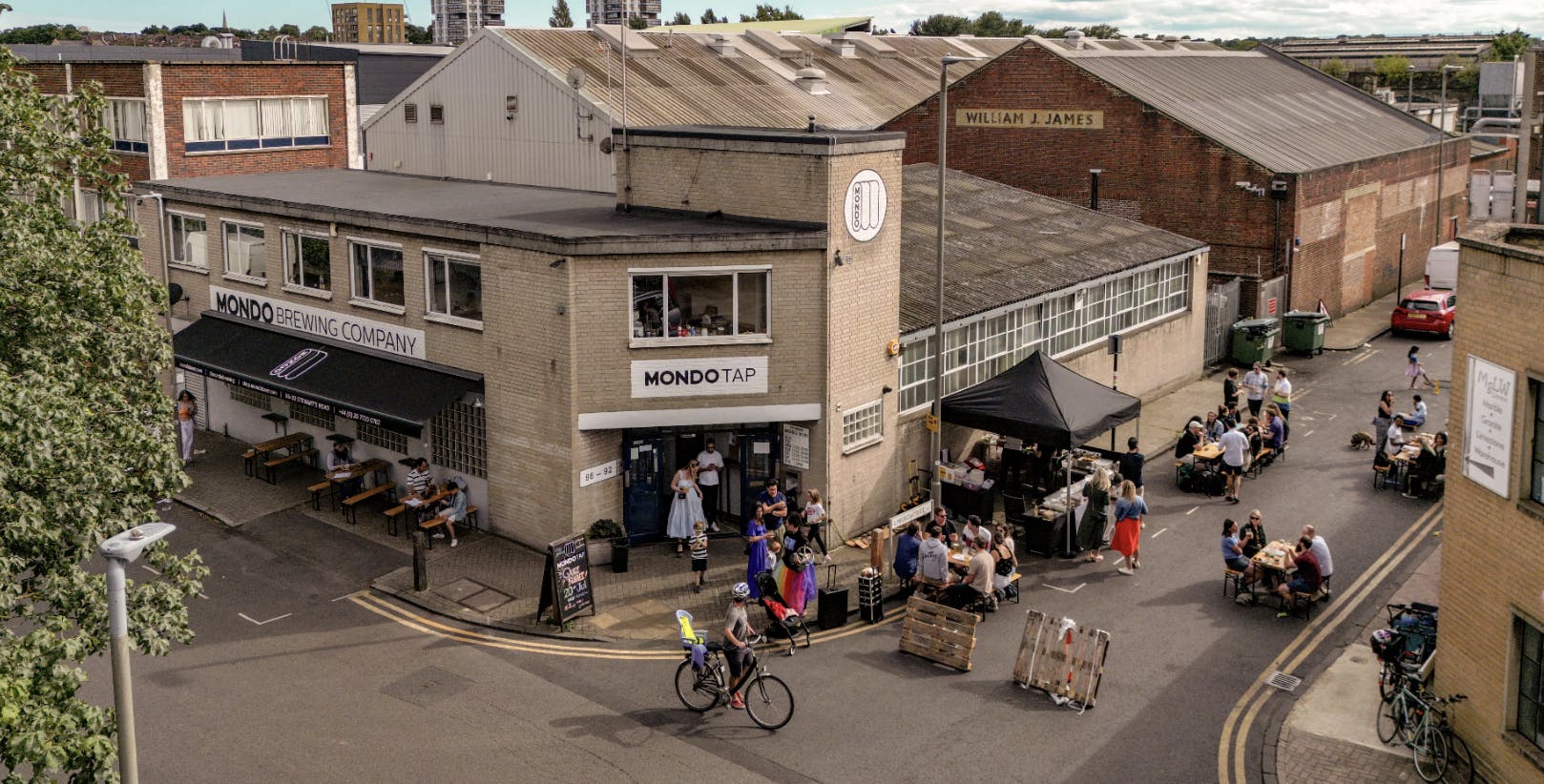 Vibrant Mondo Brewing venue with outdoor seating, perfect for events and gatherings.