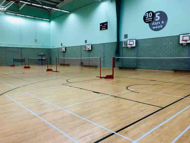 Indoor sports hall in Basildon with wooden floor for corporate events and team-building activities.