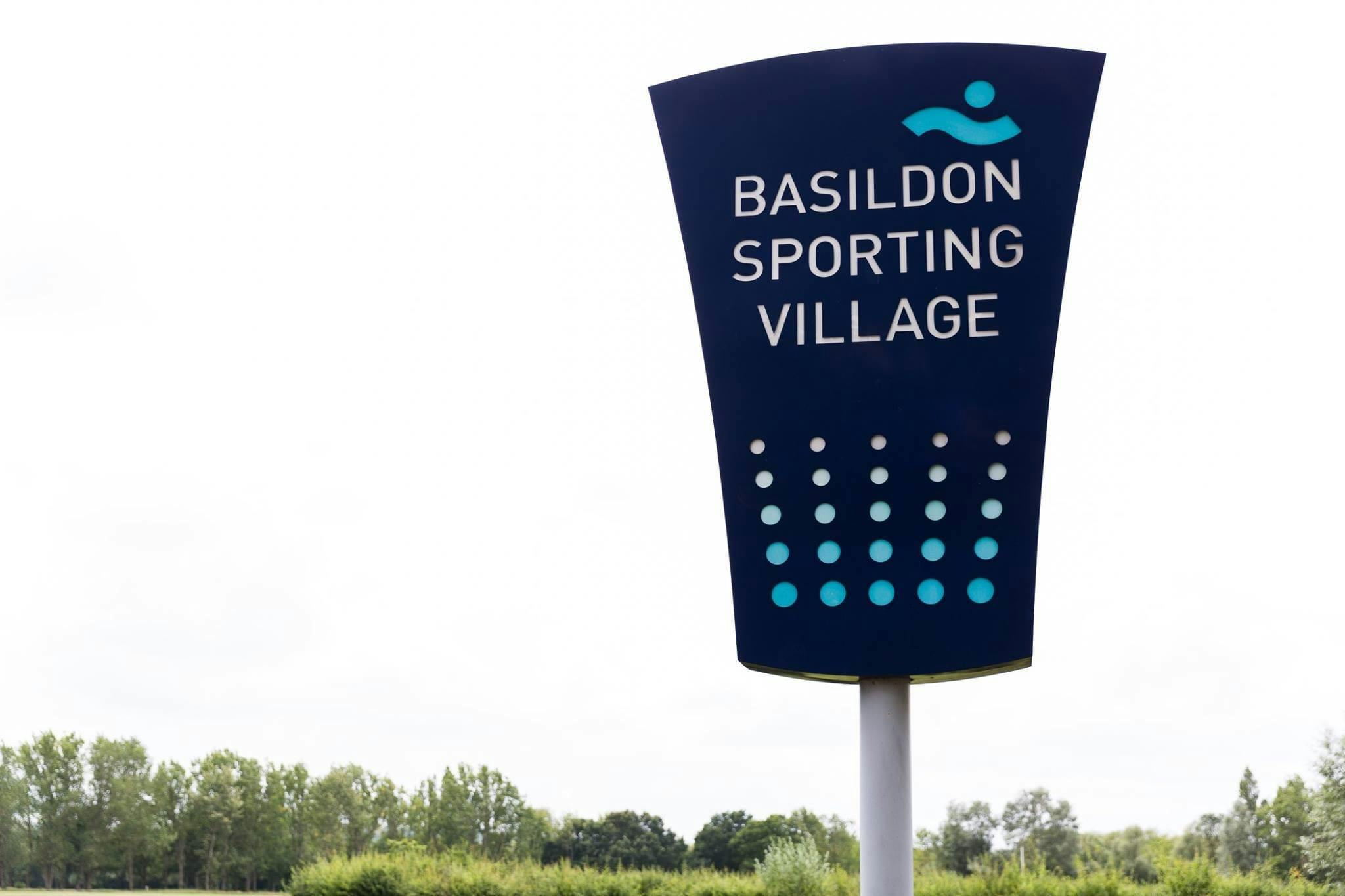 Basildon Sporting Village sign, modern venue for sports events and gatherings.