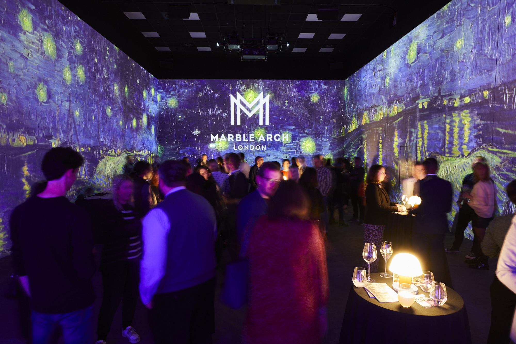 Vibrant event space with immersive projections for corporate gatherings and art events.