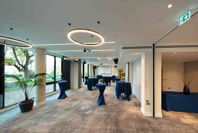 Royal Suite event space with navy tables, perfect for networking and gatherings.