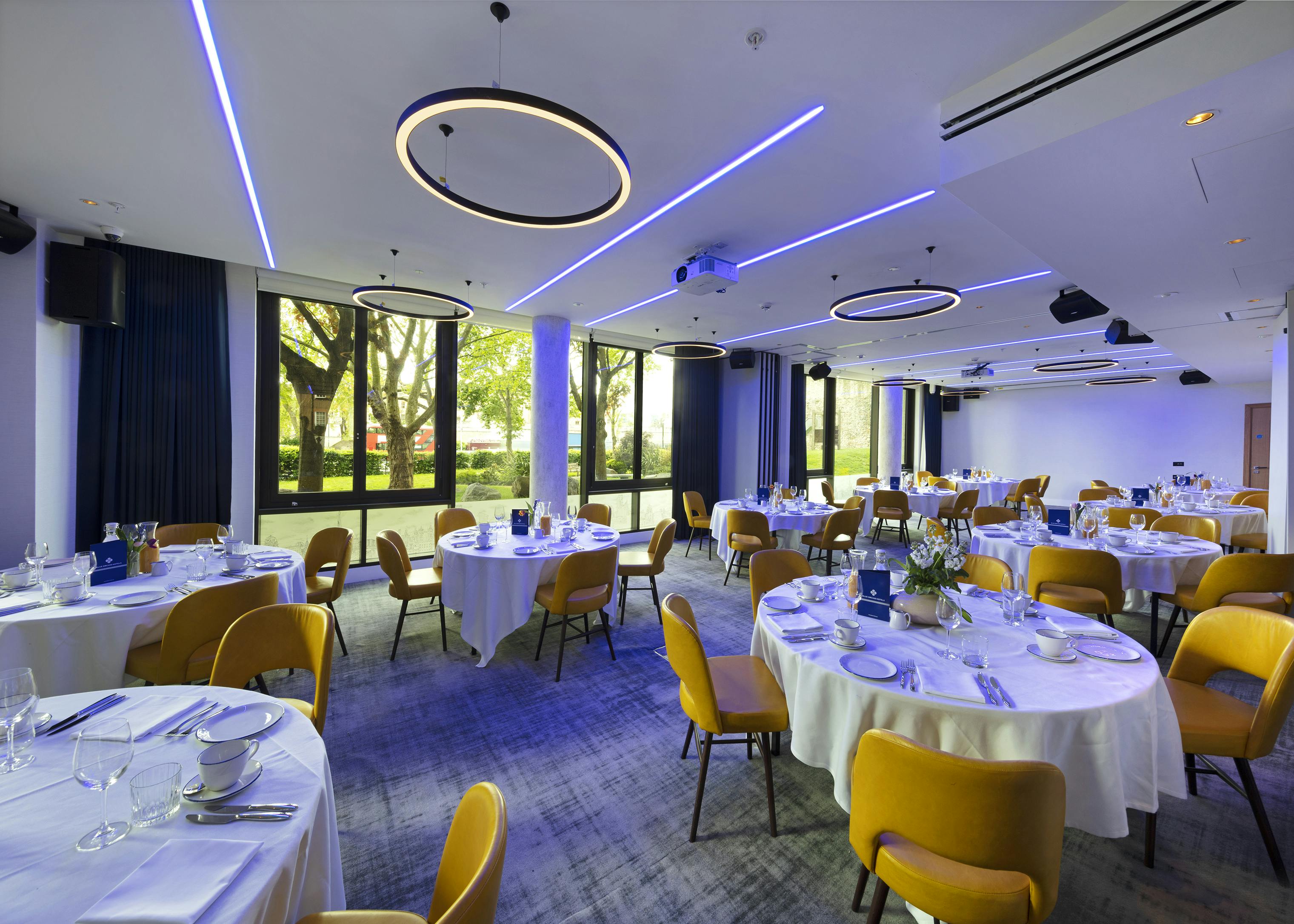 Royal Suite event space with round tables, ideal for formal gatherings and networking.