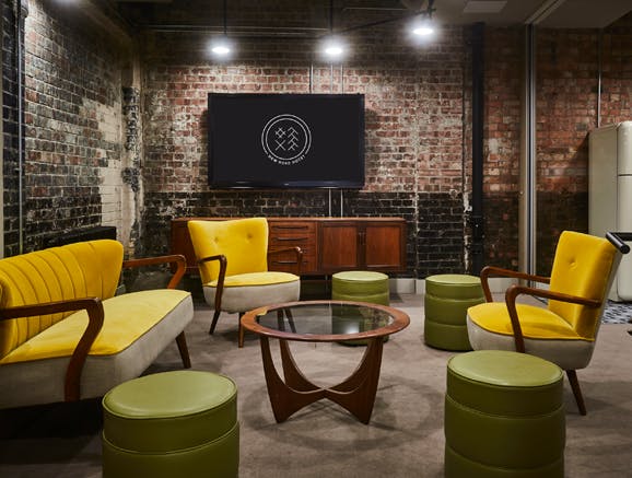 Stylish meeting space with yellow seating at New Road Hotel, ideal for creative events.