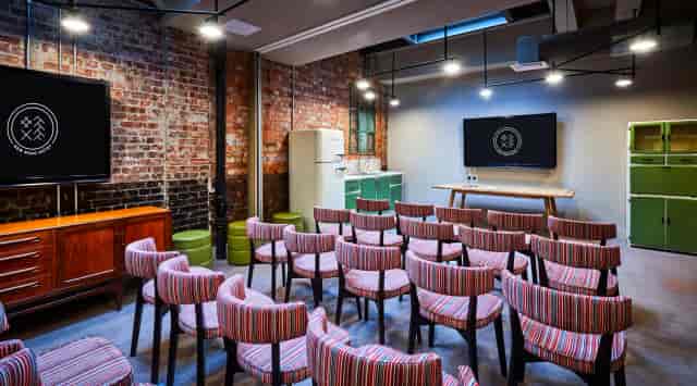 Modern meeting space with exposed brick walls, ideal for workshops and gatherings.