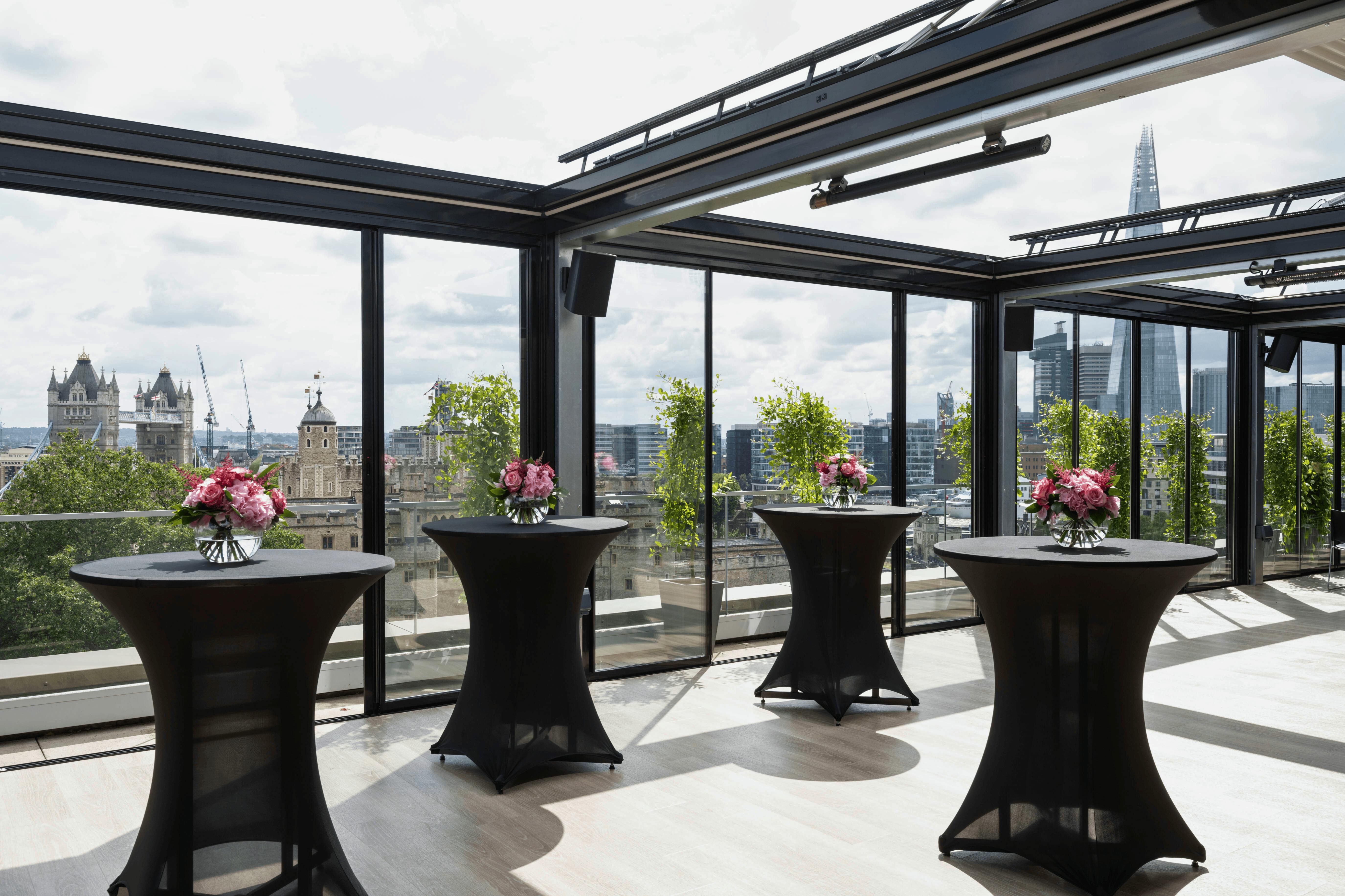 Stylish event space at Skyline London with floral centerpieces and city views.