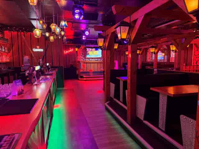 Rustic bar venue in Birmingham with karaoke stage for team building and networking events.