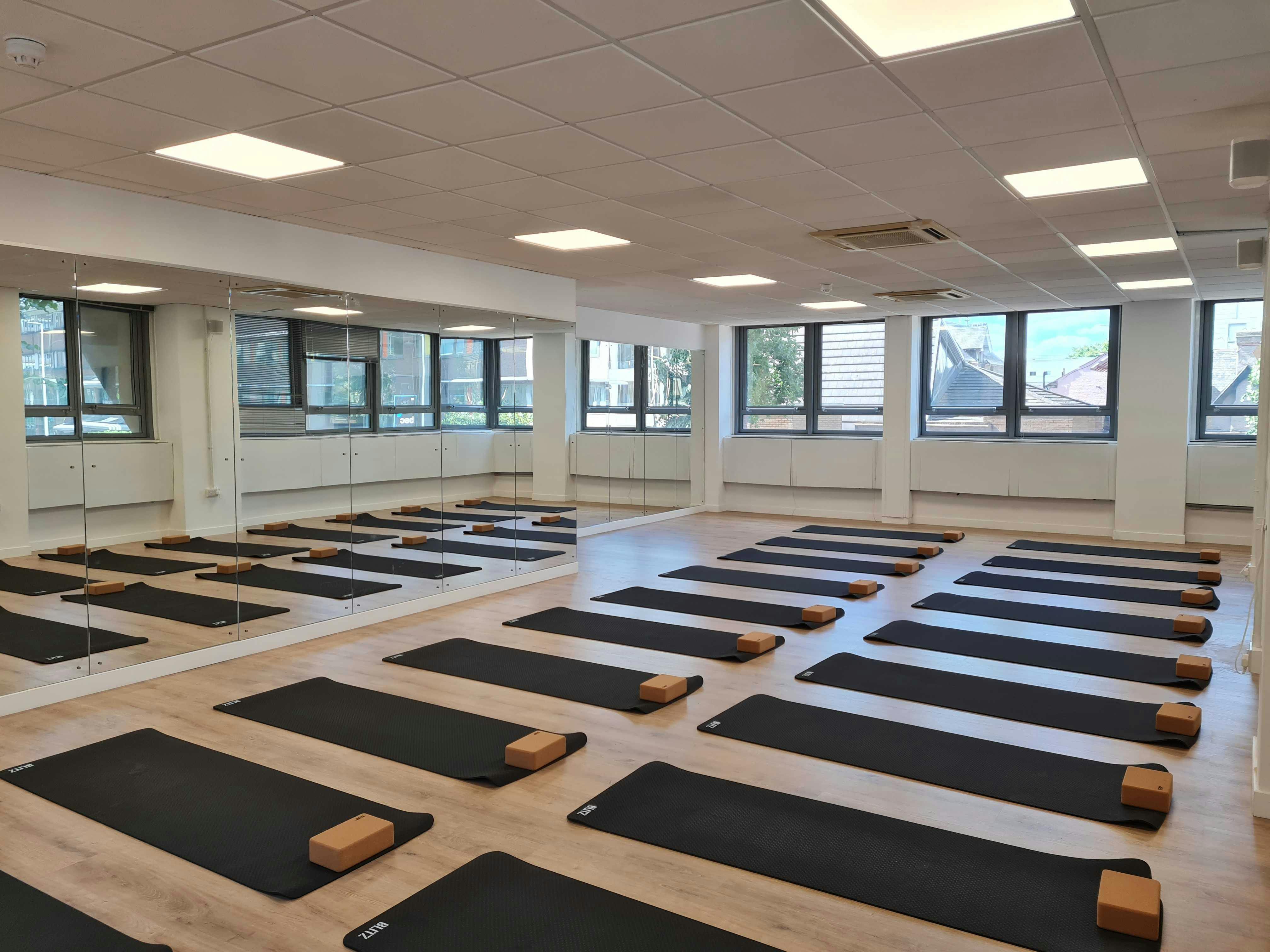 Wellness studio with yoga mats for corporate retreats and mindfulness events.