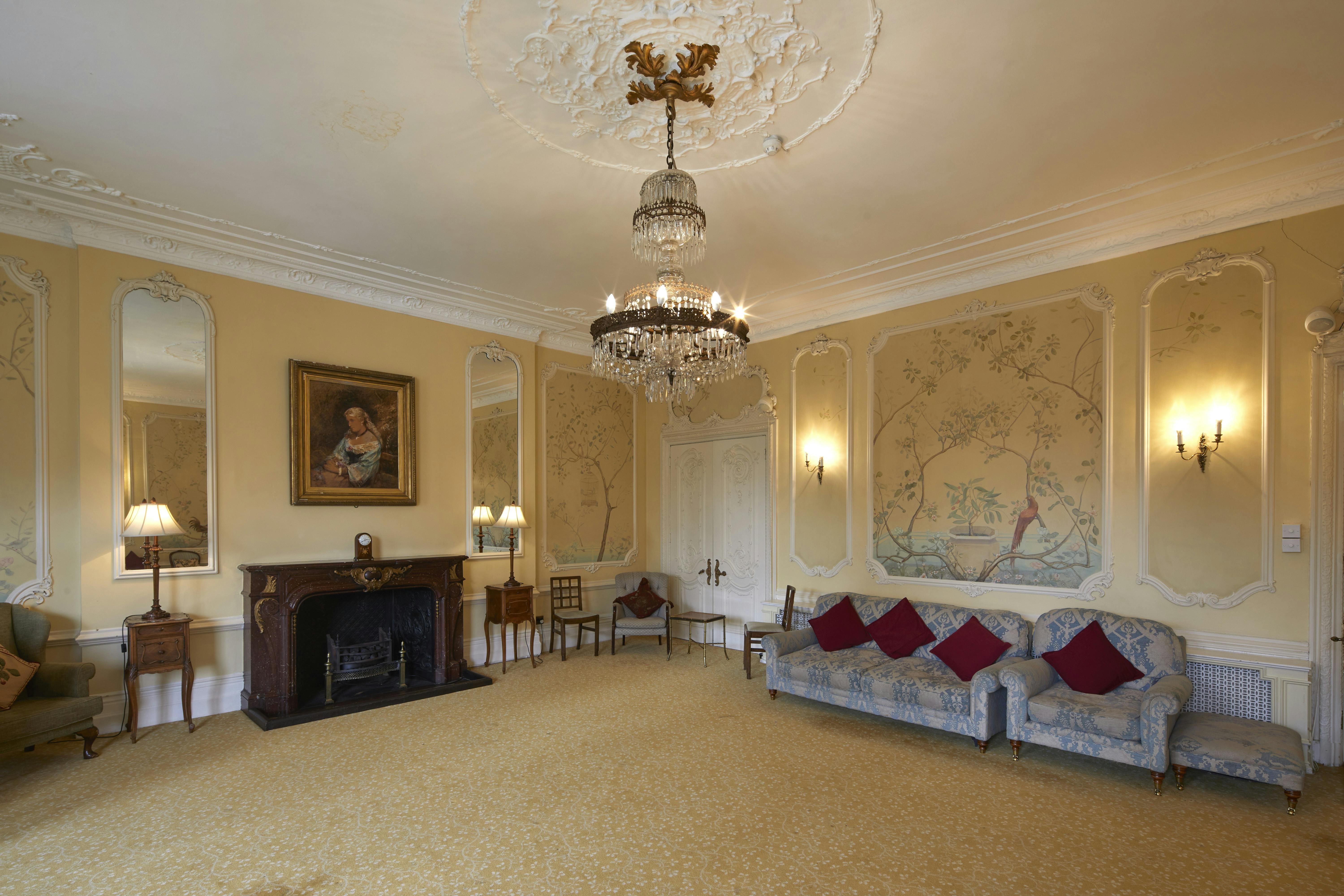Elegant meeting space with chandelier at University Women's Club for gatherings and conferences.