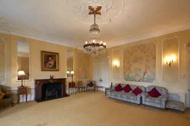 Elegant meeting space with chandelier at University Women's Club for gatherings and conferences.