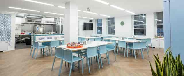 Modern meeting space with light blue chairs, ideal for workshops and networking events.