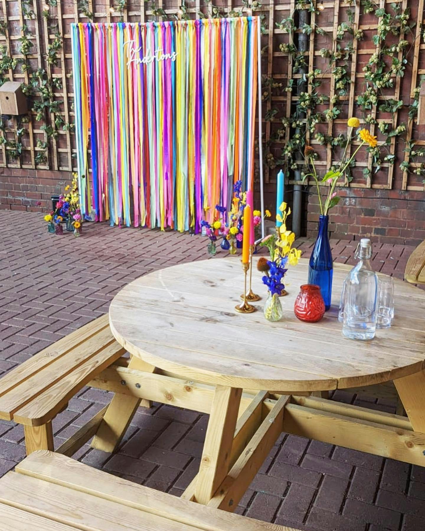 "Alphabet Brewing Company Taproom with rustic table, colorful candles for events and workshops."