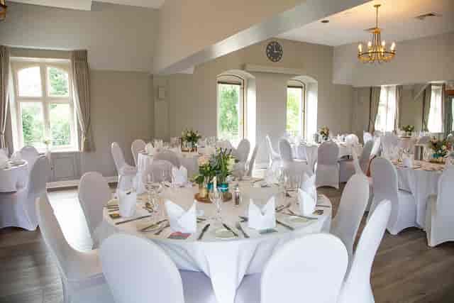 Elegant wedding venue with round tables and natural light at Badgemore Park.