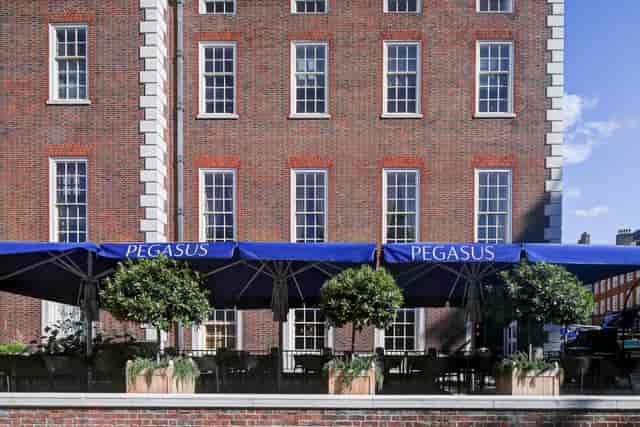 Outdoor venue at Pegasus Bar, blue awnings, ideal for summer social events and meetings.
