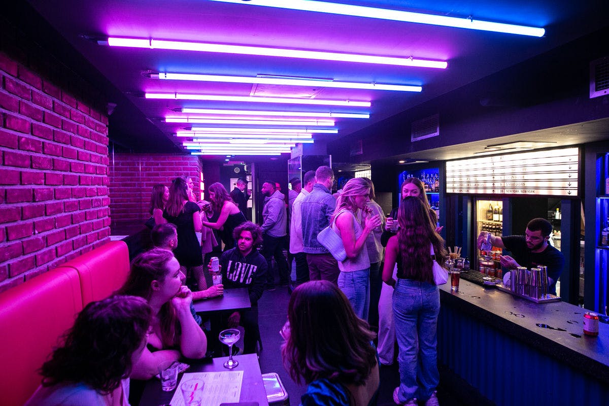 Vibrant event space with neon lighting for networking and cocktail parties at Lucky Voice Soho.