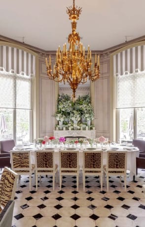 Elegant dining table with floral arrangement in upscale restaurant for intimate events.