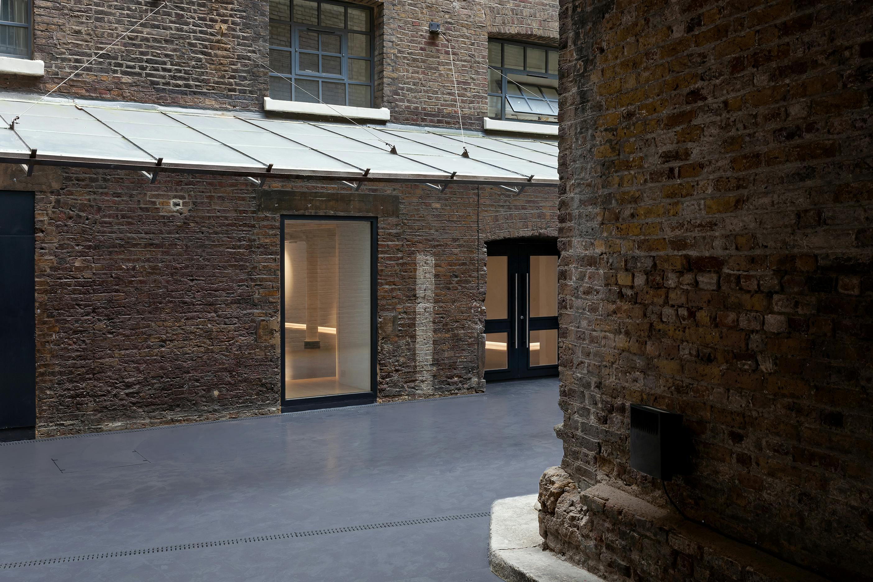 Versatile event space with exposed brick, ideal for networking events and workshops.