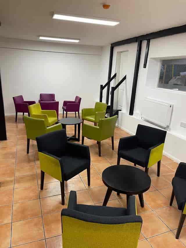 Modern Kingdom Hall with vibrant purple and green seating for networking events.
