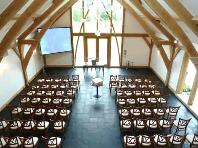 Mythe Barn event space with wooden beams, ideal for corporate meetings and workshops.