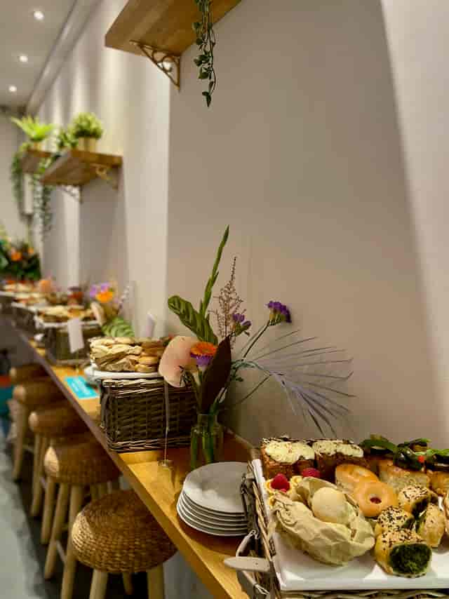 Buffet setup with flowers at The Luxury Picnic Cafe for elegant events and gatherings.