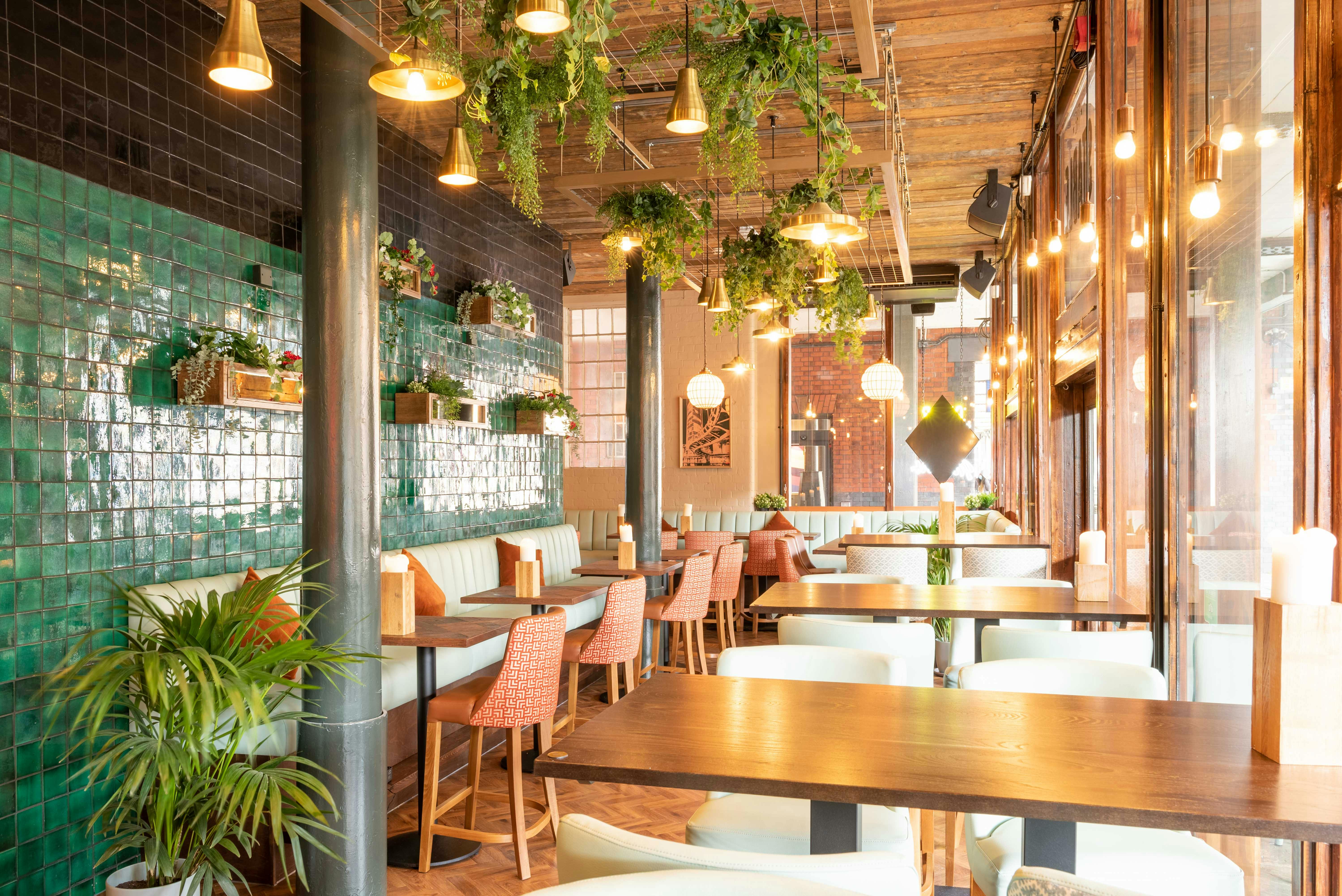 Stylish restaurant interior with green tiles, ideal for networking events and gatherings.