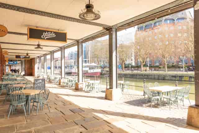 Charming waterfront venue with outdoor seating for casual meetings and events.