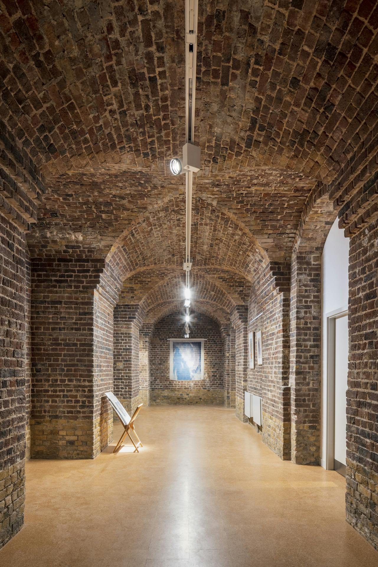 Old Crypt brick archway venue for intimate gatherings and art exhibitions.