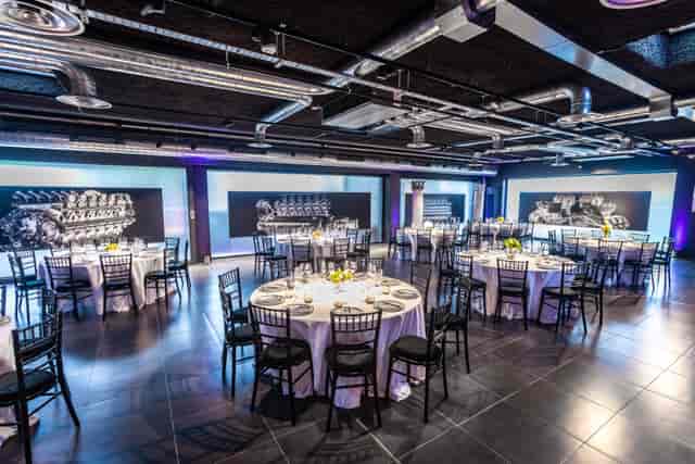 Elegant event space with round tables, ideal for networking and celebrations.