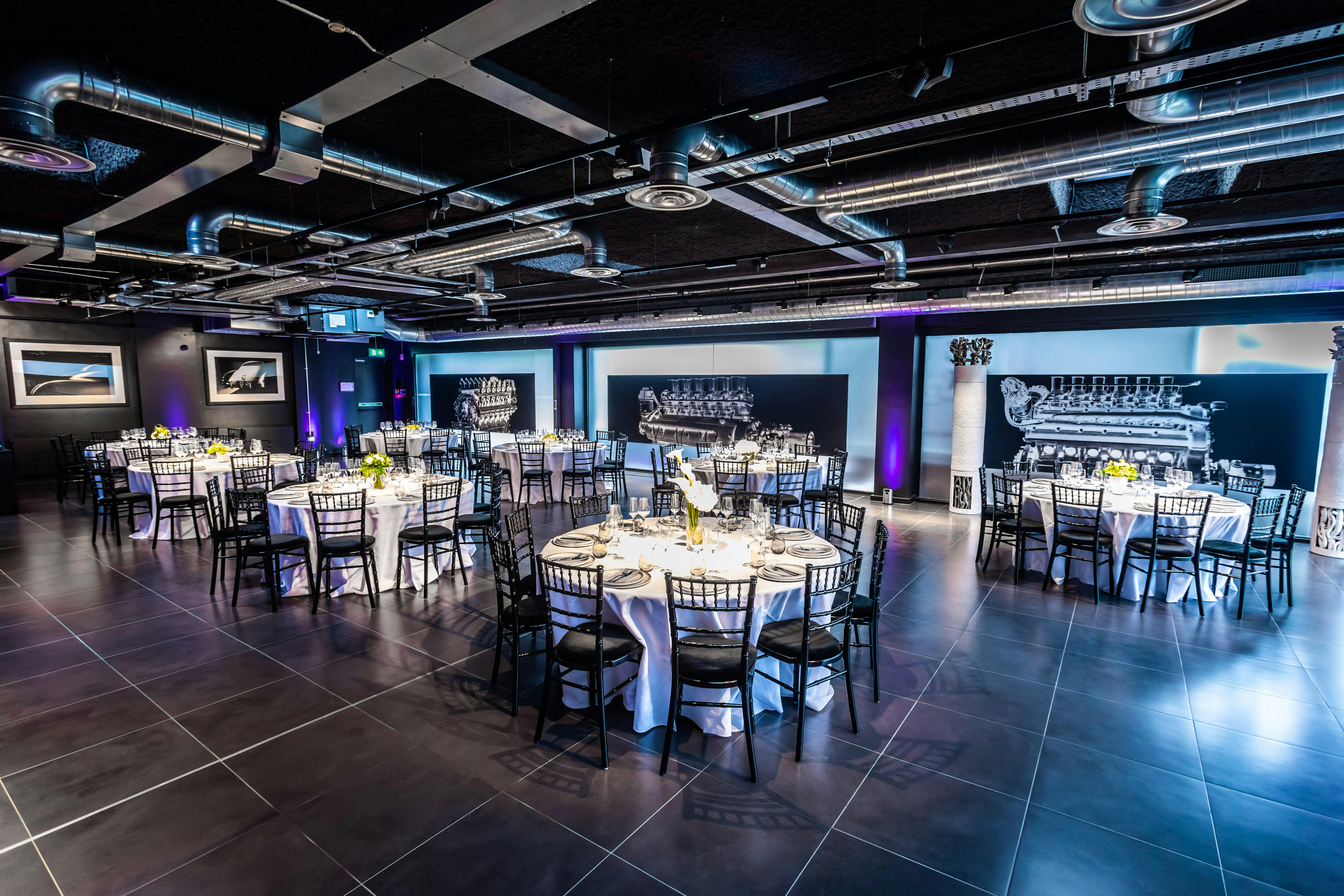 Elegant event space with round tables, ideal for corporate gatherings and weddings.